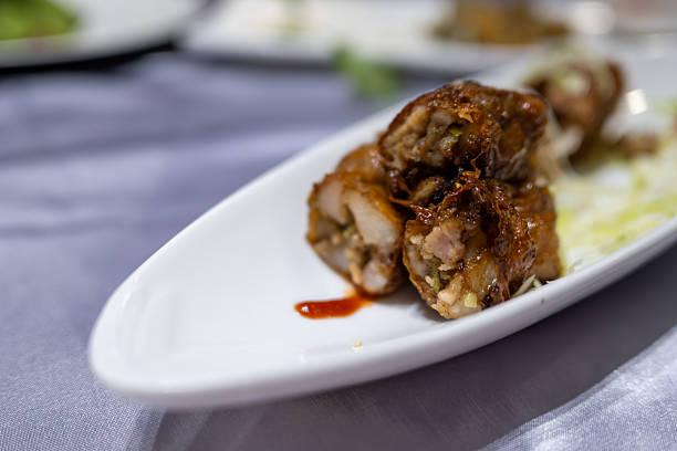 Delicious Grilled Meat Rolls Served with Sauce on a White Plate