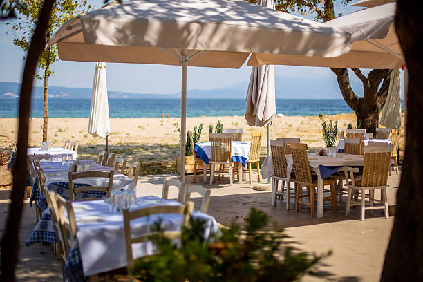 istock Beach restaurant tables set for lunch overlooking tranquil sea 2234658384