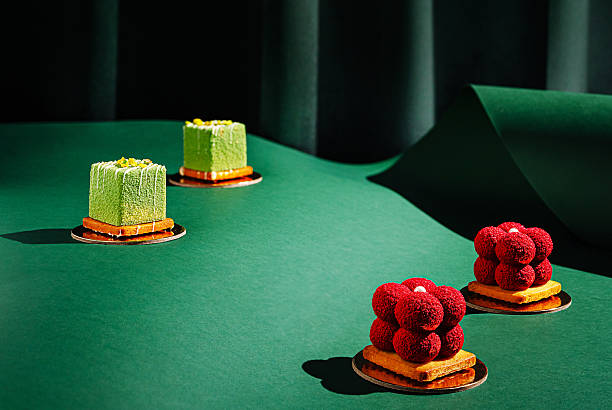 Exquisite dessert display with colorful cakes on green backdrop