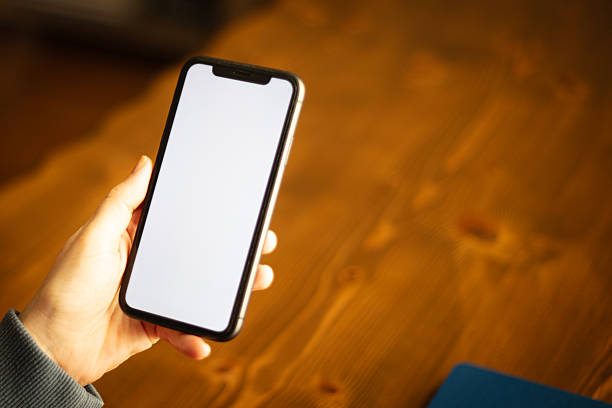 istock Unrecognizable woman is holding mobile phone, white mobile phone screen. 2234658666