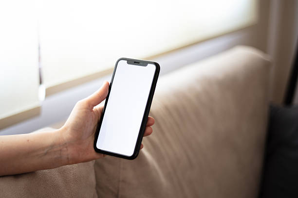 istock Unrecognizable woman is holding mobile phone, white mobile phone screen. 2234658704