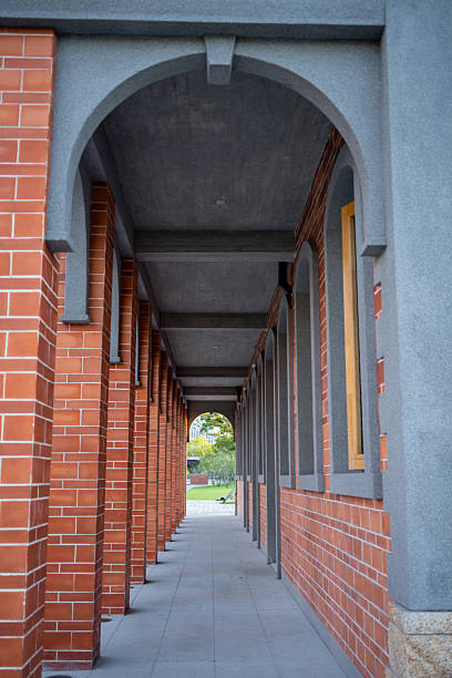 istock A Serene Corridor Under Red Brick Arches Leading to a Lush Green Garden 2234658894