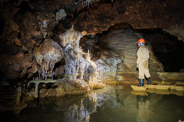 istock A speleologist explores a majestic cave, illuminated by a headlamp 2234659811