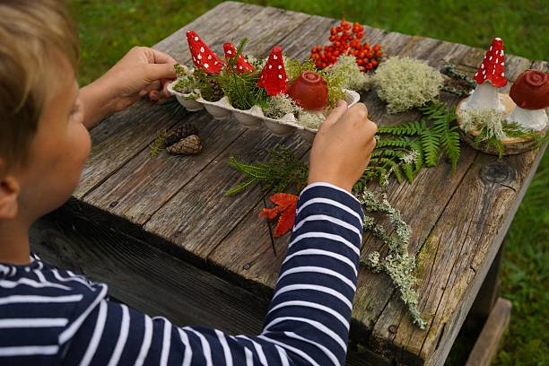 istock Eco-friendly autumn craft with natural and recycled elements, creating a mushroom figure. 2234659825