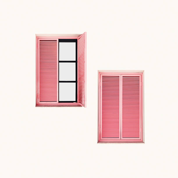 istock Minimal summer aesthetic two pink shutter windows on light pink wall. Natural sunlight creates soft shadows, modern design. Concepts of summer, vacation, tropical style, architecture, home decor 2234660398