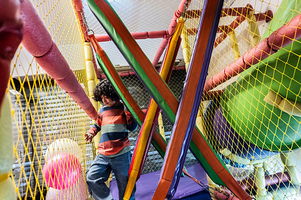 istock Boy having fun at the playground inside a party hall 2234660795