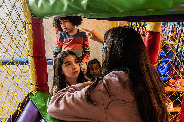 istock Friends having fun at the playground inside a party hall 2234661379