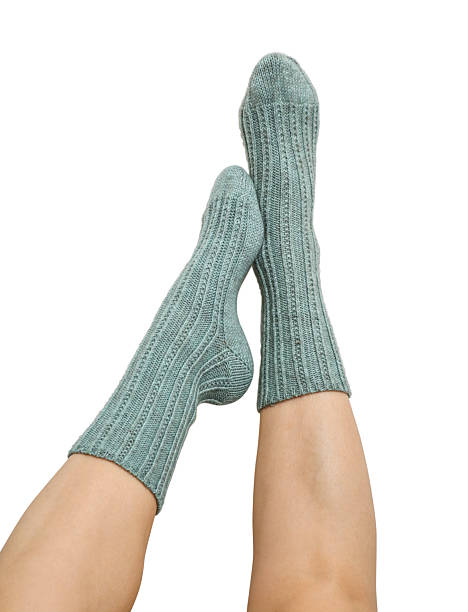 istock Female legs in blue hand knitted wool socks 2234662179