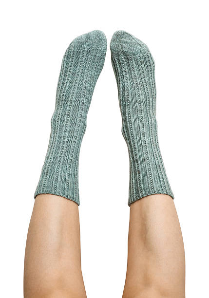 istock Female legs in blue hand knitted wool socks 2234662187