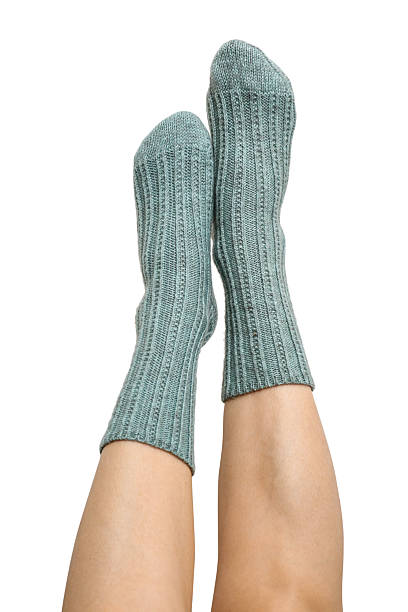 istock Female legs in blue hand knitted wool socks 2234662191