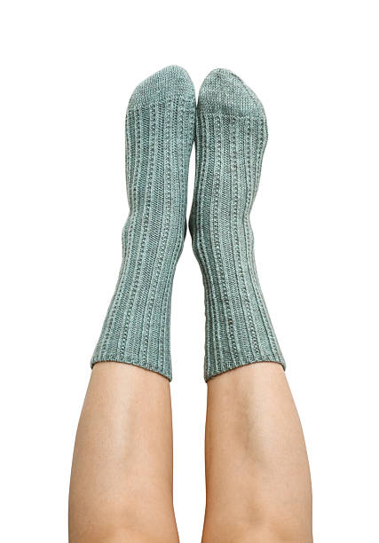 istock Female legs in blue hand knitted wool socks 2234662192