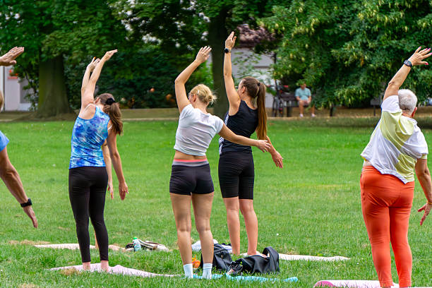 Young sporty woman doing stretching exercises by the river