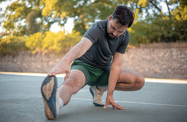 istock A focused and athletic male getting ready for a training session with full-body stretches 2234663149