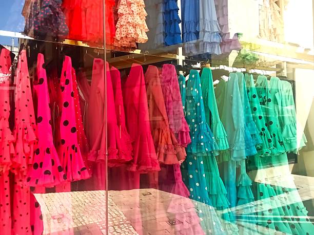 Cadiz, Spain  -  Reflection of the city Street in the window glass of the store .Traditional dresses.Spanish flamenco dresses  in Cadiz, Andalusia, Spain.