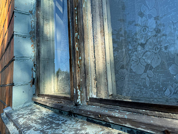istock Window in a brick house. Dilapidated window frame. Close-up. 2234665295
