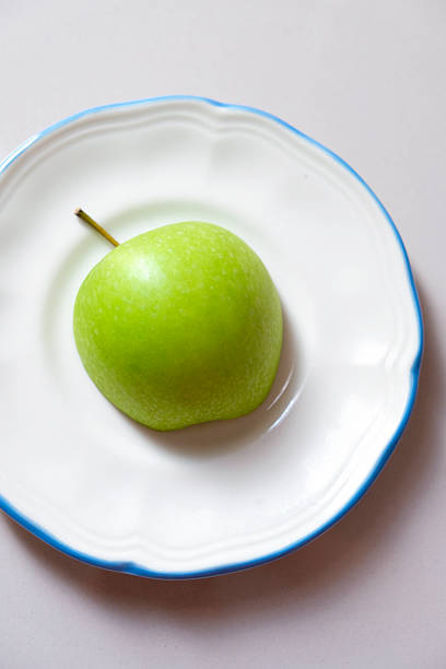 Close-up of a green apple on a plate