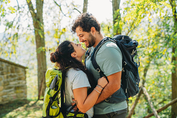 istock A couple is embracing together in the forest while they are taking a break from the hike 2234667721