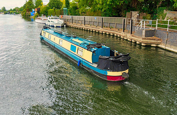 istock Canal boat navigating Thames River waterway 2234668578