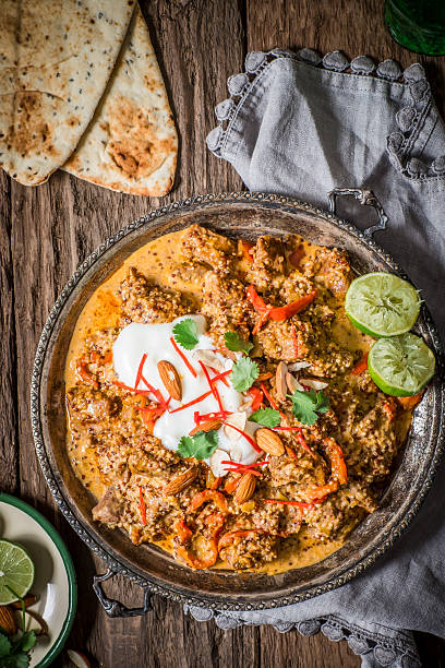 istock Traditional Indian Curry Dish with Yoghurt and Spices on Rustic Wooden Table 2234670211