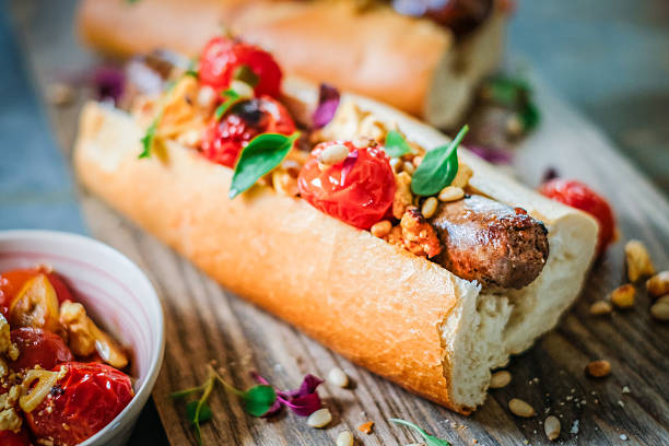istock Gourmet Sausage Sandwich with Roasted Cherry Tomatoes and Pine Nuts Garnish 2234671019