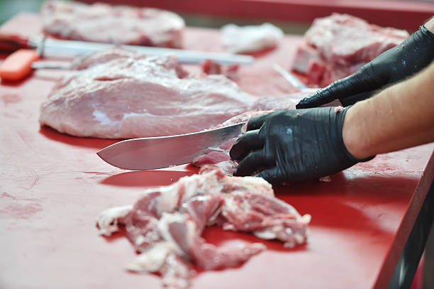 istock Butcher cutting pork primal meat cuts 2234672734