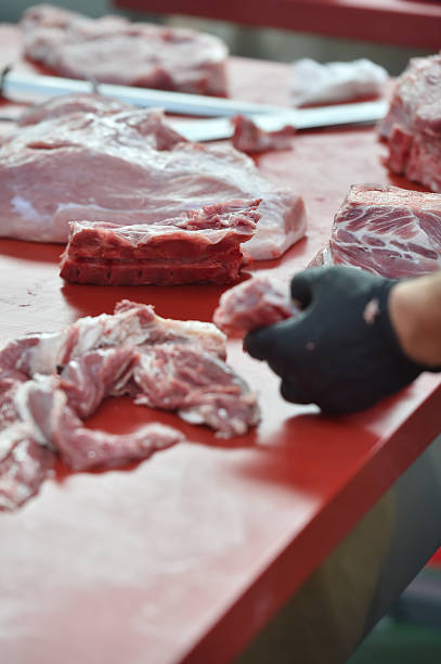 istock Butcher cutting pork primal meat cuts 2234672736