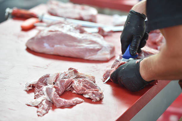 istock Butcher cutting pork primal meat cuts 2234672744