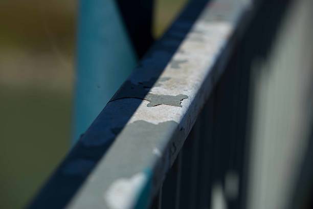 Weathered metal railing with peeling paint in natural light, lifestyle