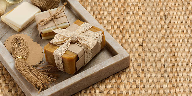 istock Handmade soap bars on marble stand and packaging items on table 2234675374