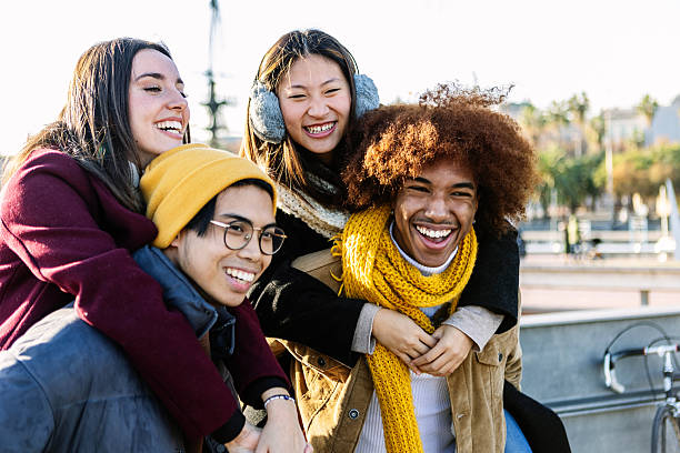 istock Happy multi-ethnic friends having fun piggybacking outdoors in winter 2234675609