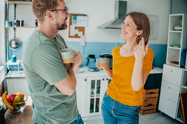 istock Joyful interaction between young adults in a cozy domestic kitchen during morning hours 2234675864