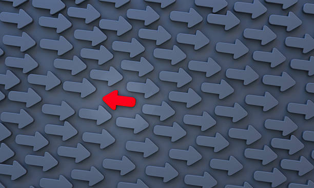 istock Red arrow points in the opposite direction to the black arrows, . 2234682183