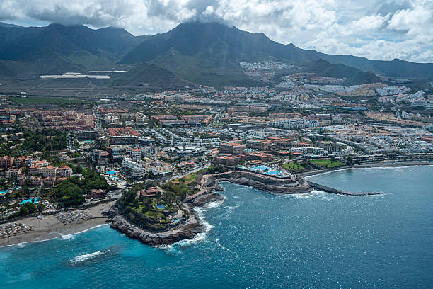 istock A city with a beach and mountains in the background. 2234685628