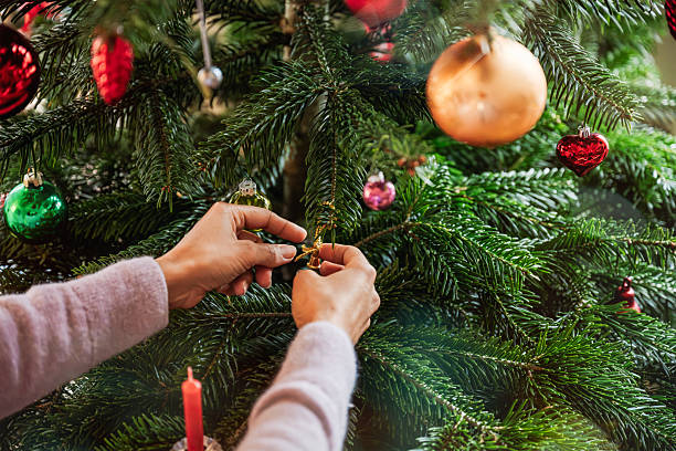 istock female hands decorating christmas tree with  retro christmas balls 2234686286