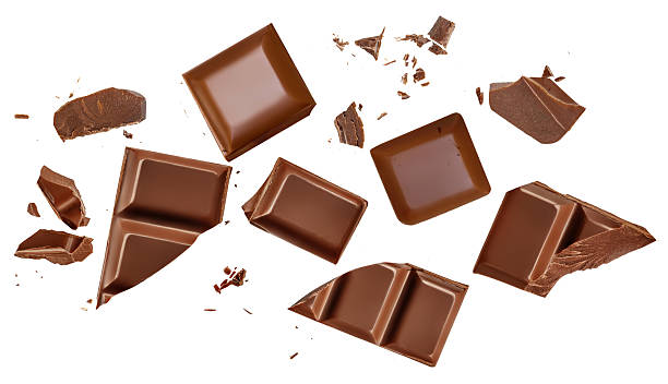istock Broken chocolate bar pieces isolated on white. High-Quality Chocolate Explosion with scattered  cocoa crumbs and chunks Top view. Flat lay. Pattern  2234686348