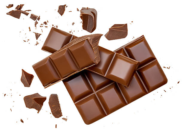 istock Broken chocolate bar pieces isolated on white. High-Quality Chocolate Explosion with scattered  cocoa crumbs and chunks Top view. Flat lay. Pattern  2234686349