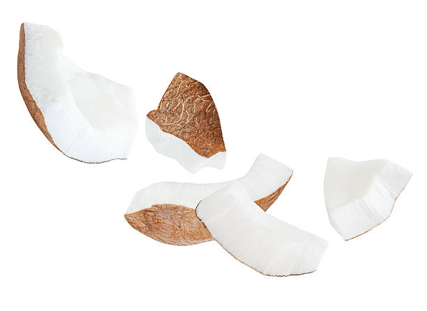 istock Broken Coconut pieces  isolated on white. High-Quality Coconut Explosion with coco nut slices and chunks Top view. Flat lay. Pattern  2234686505
