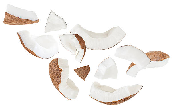 istock Broken Coconut pieces  isolated on white. High-Quality Coconut Explosion with coco nut slices and chunks Top view. Flat lay. Pattern  2234686509
