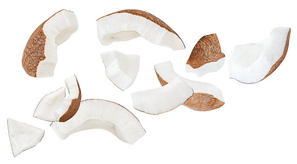 istock Broken Coconut pieces  isolated on white. High-Quality Coconut Explosion with coco nut slices and chunks Top view. Flat lay. Pattern  2234686510