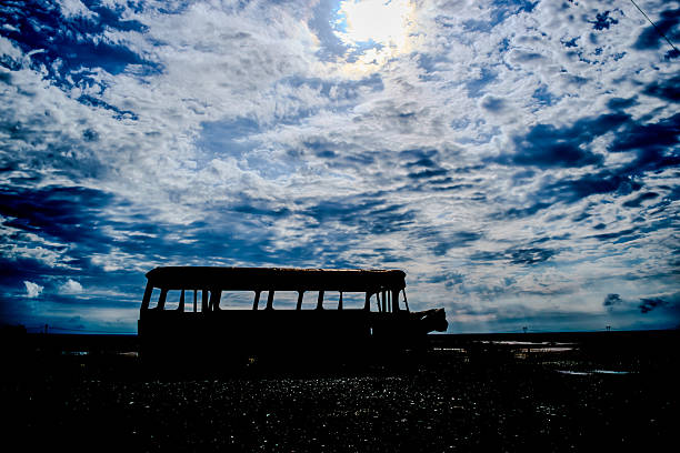 Abandoned rusty bus and car in desert