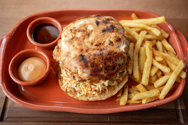istock Savory sandwich and crispy fries served on a rustic plate for lunch 2234688319