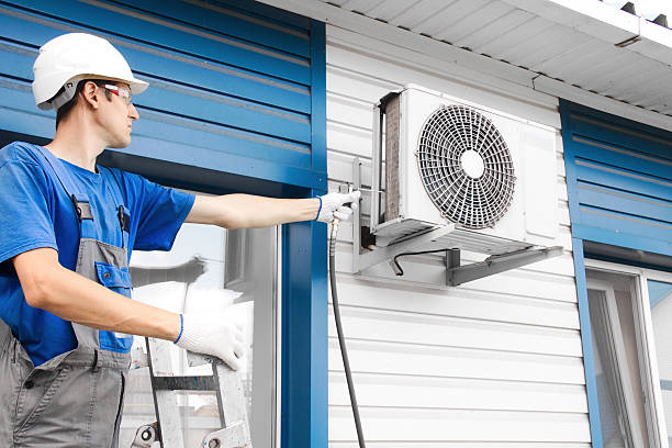 istock Caucasian male technician installing outdoor air conditioning unit on building 2234688494