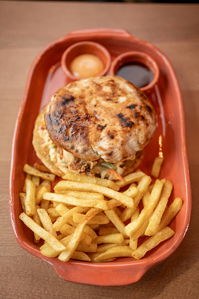 istock Savory burger and crispy fries served in a rustic style dish 2234689104