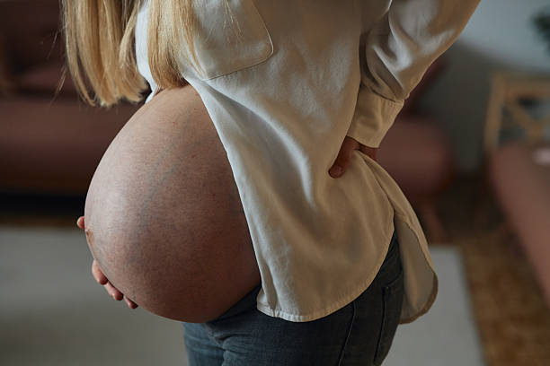 istock Pregnancy pain in back 2234689696
