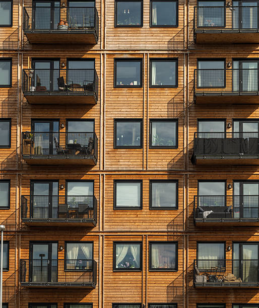 Wooden apartment facade with uniform balconies.