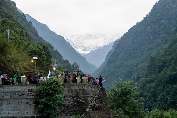 A breathtaking view of the Himalayan mountains covered in lush green forests along the trekking path to Kedarnath in Uttarakhand, India. The layered ridges and serene valley showcase the pristine beauty of the Garhwal Himalayas, offering a glimpse of the adventure and spirituality that define the Kedarnath pilgrimage journey. This natural landscape is ideal for themes of trekking, travel, spirituality, and eco-tourism.