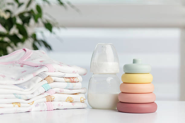 istock Baby bottle with stacking rings and folded clothes 2234696133