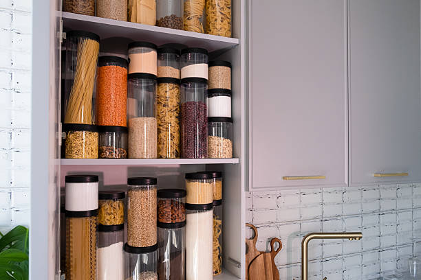 istock Organized kitchen pantry with cylindrical plastic jar for storing loose products,  in grey tones 2234697076