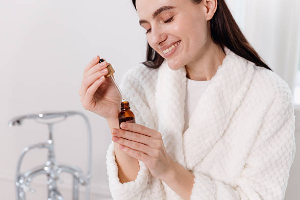 istock Young woman enjoying a skincare routine in a modern bathroom setting 2234697414