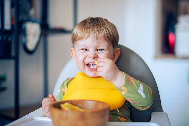 istock Cute toddler boy eating all by himself. 2234697514